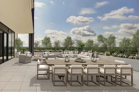 a view of a patio with dining table and chairs