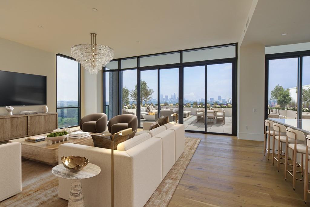 2425 Peachtree Street Northeast, Unit 1505 Atlanta, GA 30305 - Photo 4 of 25 a living room with furniture large windows and a flat screen tv
