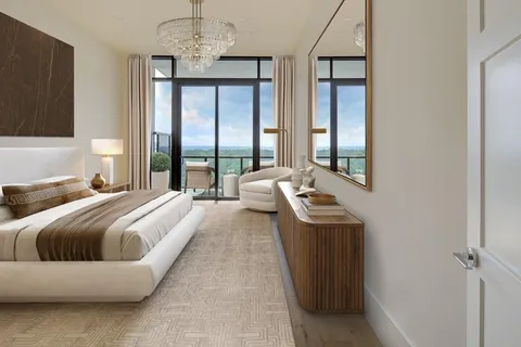 a bedroom with a bed a mirror and a window