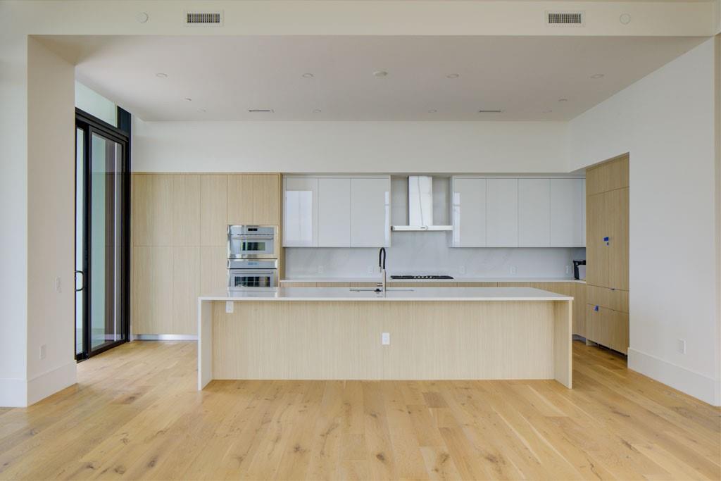 2425 Peachtree Street Northeast, Unit 1505 Atlanta, GA 30305 - Photo 9 of 25 a large kitchen with a wooden floor and a sink