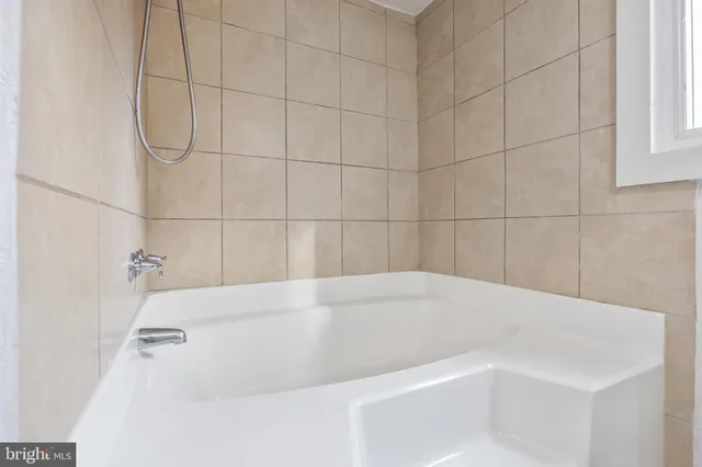 a white bath tub sitting in a bathroom