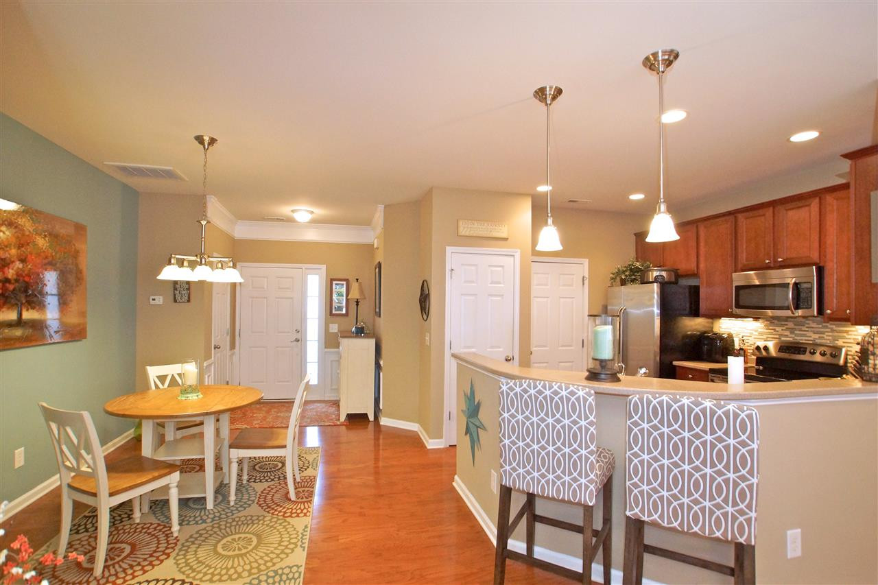 7140 Racine Way Raleigh, NC 27615 - Photo 7 of 29 Kitchen counter provides extra space to eat. Kitchen and Dining Area