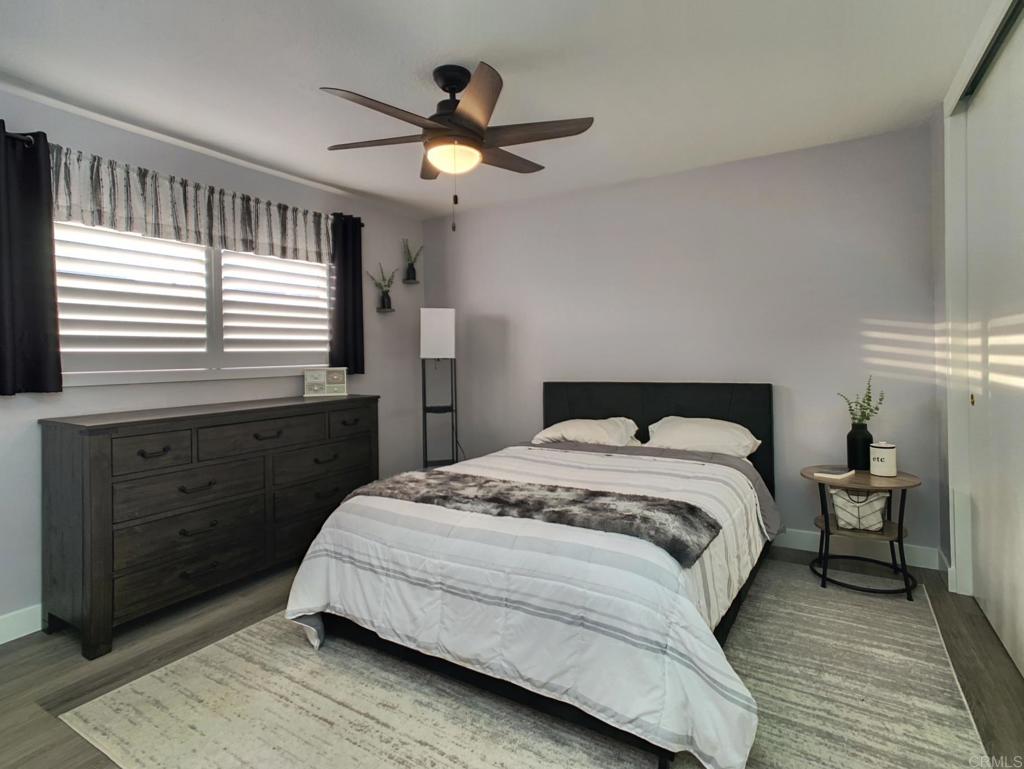 10005 3 Oaks Way Santee, CA 92071 - Photo 13 of 25 a bedroom with a bed and a chandelier