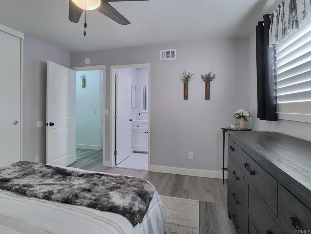 10005 3 Oaks Way Santee, CA 92071 - Photo 14 of 25 a bedroom with a granite countertop sink and a mirror