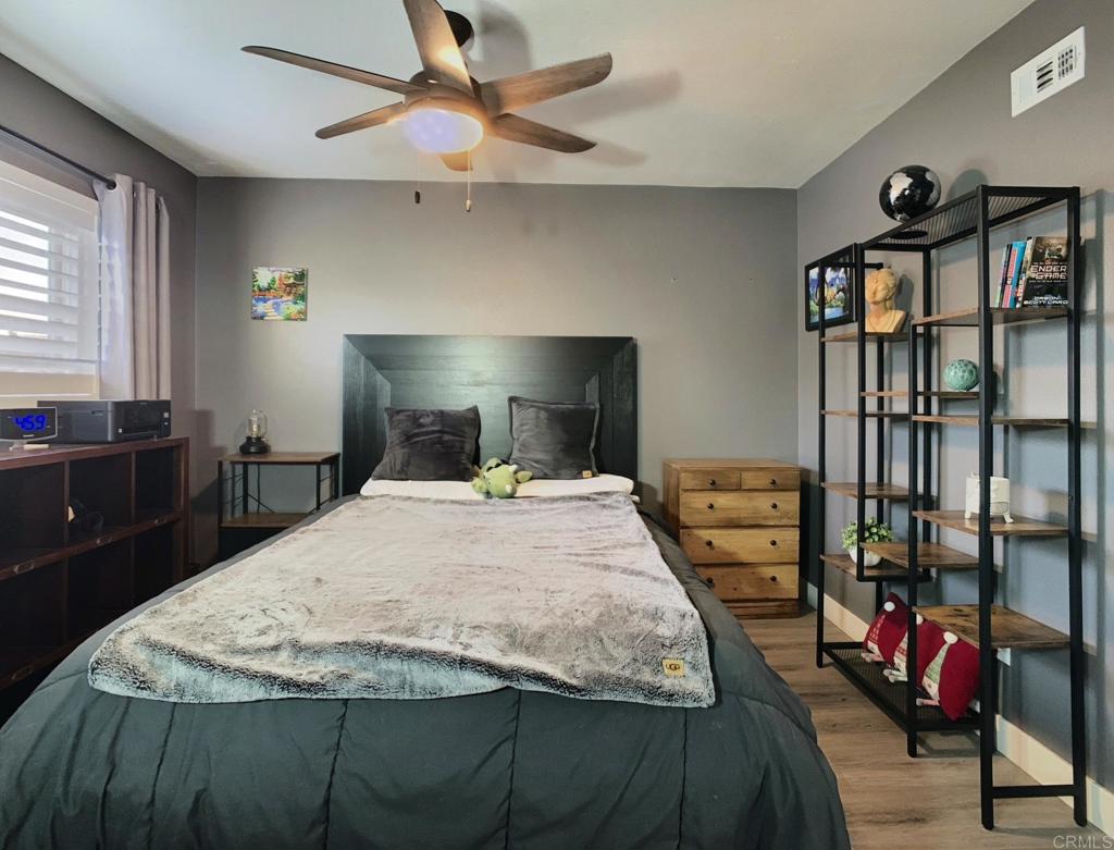 10005 3 Oaks Way Santee, CA 92071 - Photo 16 of 25 a bedroom with a bed and dresser with mirror