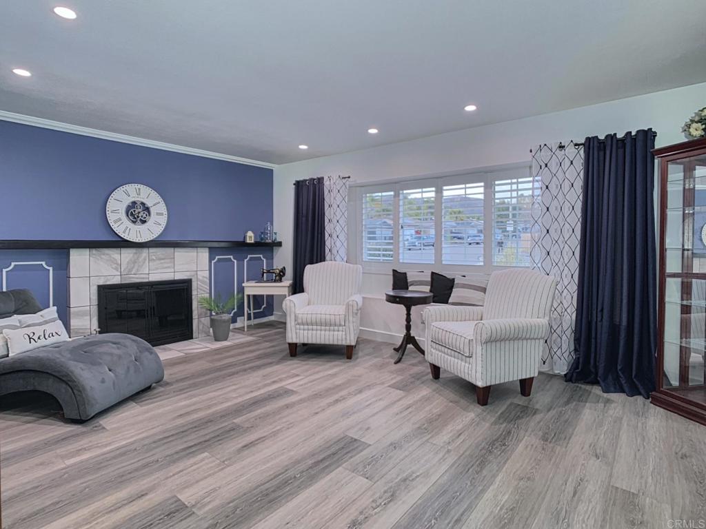 10005 3 Oaks Way Santee, CA 92071 - Photo 5 of 25 a living room with furniture a fireplace and a large window
