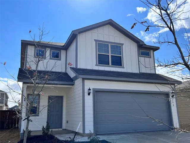 a front view of a house with a garage