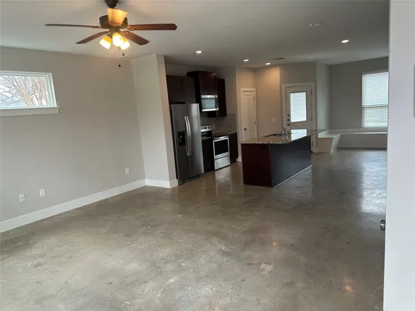 a view of a livingroom with a ceiling fan and window