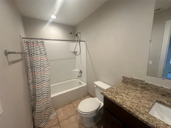 an empty room with windows and a ceiling fan