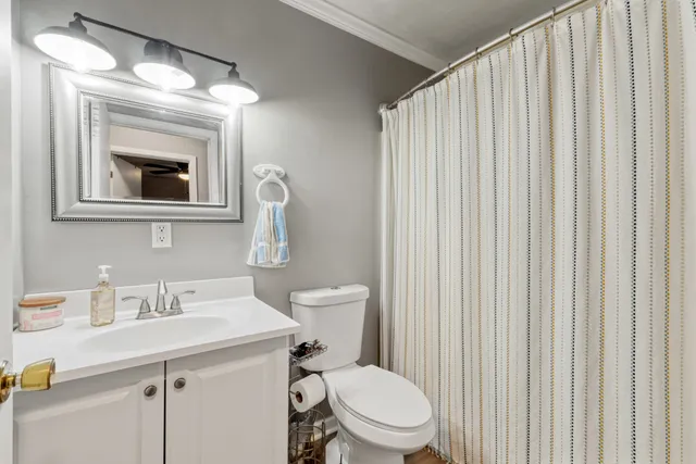 a bathroom with a toilet a sink and a mirror