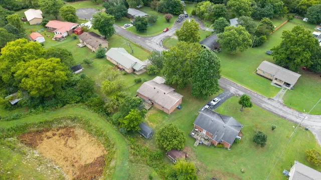 an aerial view of a house with a yard