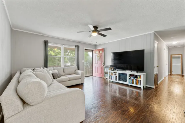 a living room with furniture and a flat screen tv