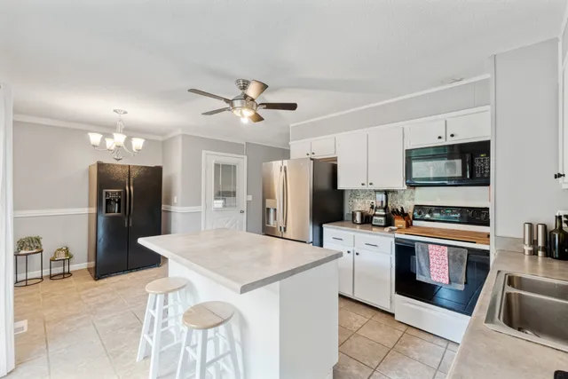 a kitchen with stainless steel appliances a refrigerator sink and stove