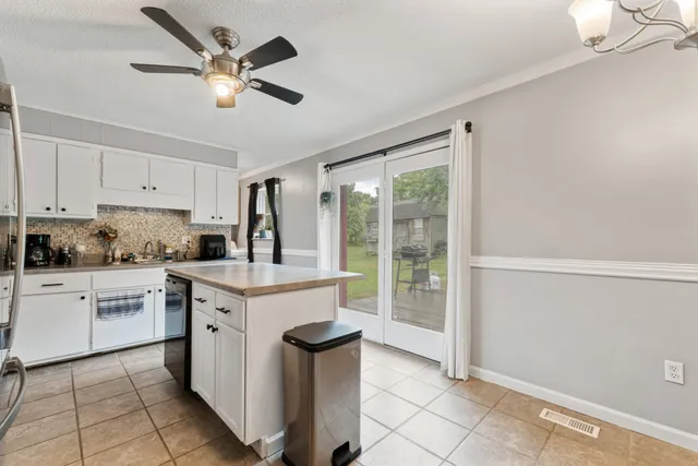 a kitchen with a stove a sink dishwasher and a refrigerator