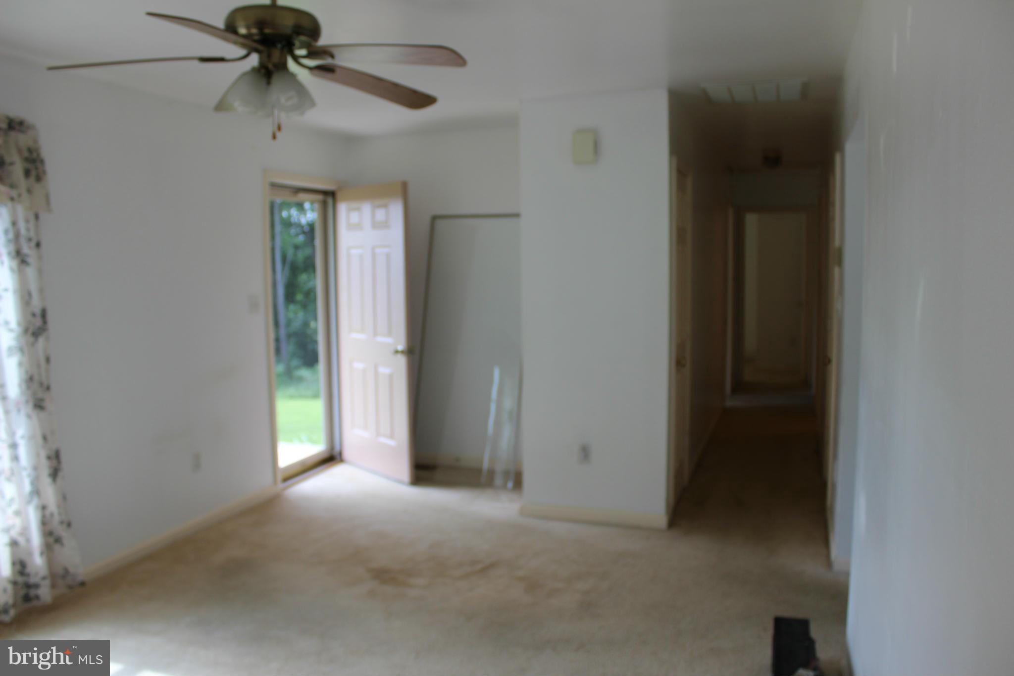 2880 Basford Road Frederick, MD 21703 - Photo 3 of 17 an empty room that has a window and a fan