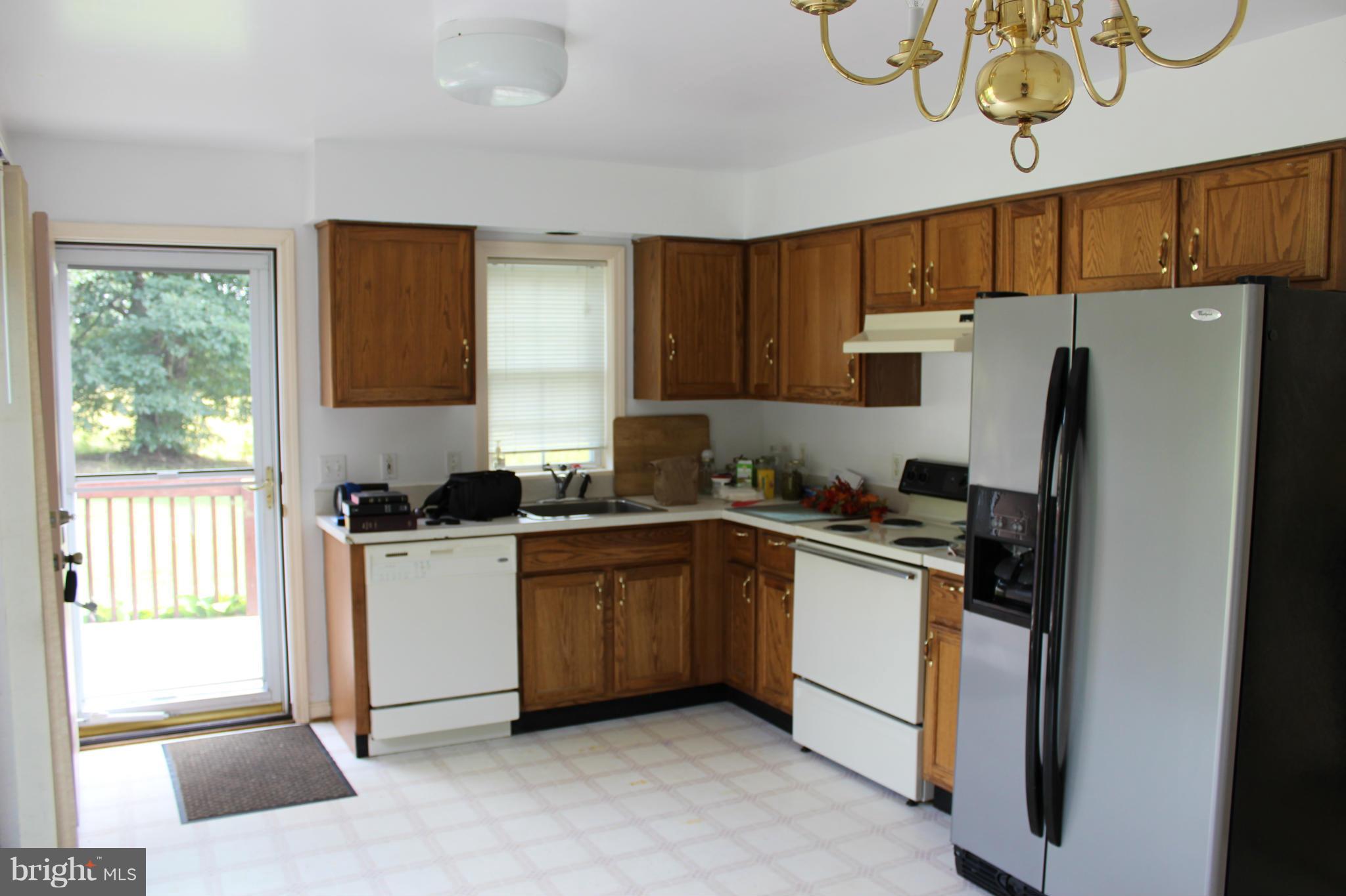 2880 Basford Road Frederick, MD 21703 - Photo 4 of 17 a kitchen with stainless steel appliances granite countertop a refrigerator sink and cabinets