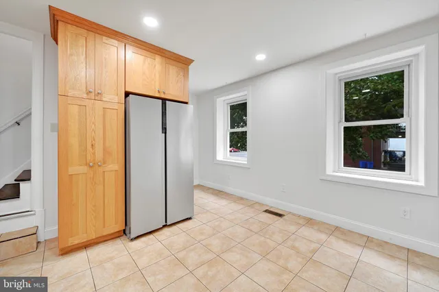 an empty room with windows and closet