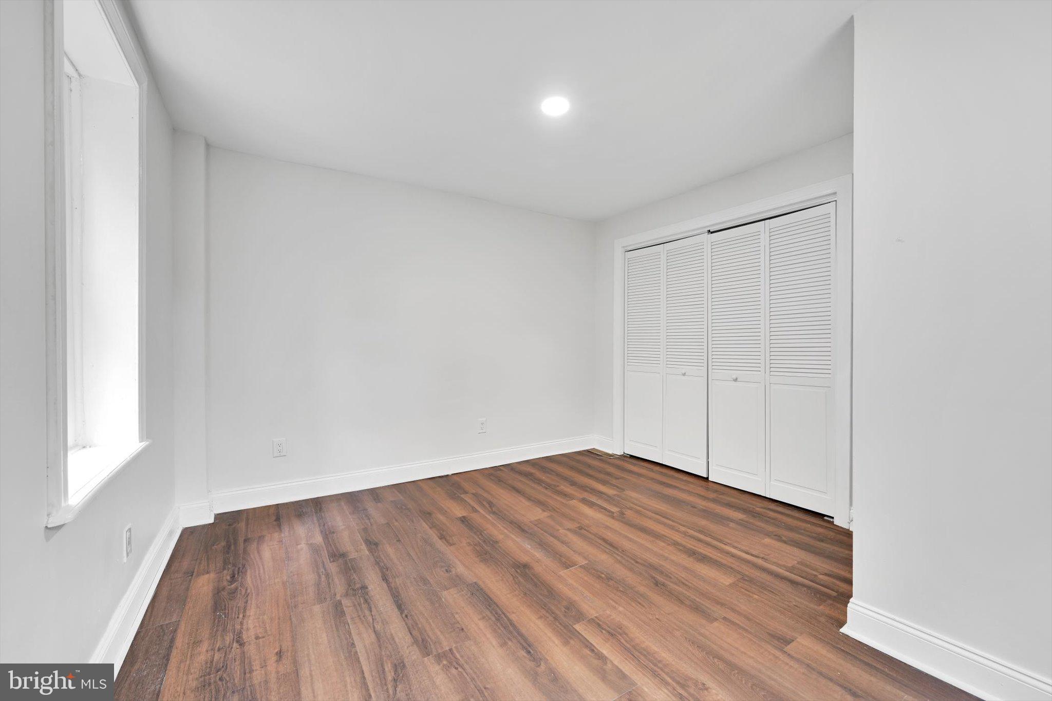 3964 Penn Avenue Sinking Spring, PA 19608 - Photo 18 of 30 a view of an empty room with wooden floor and a window