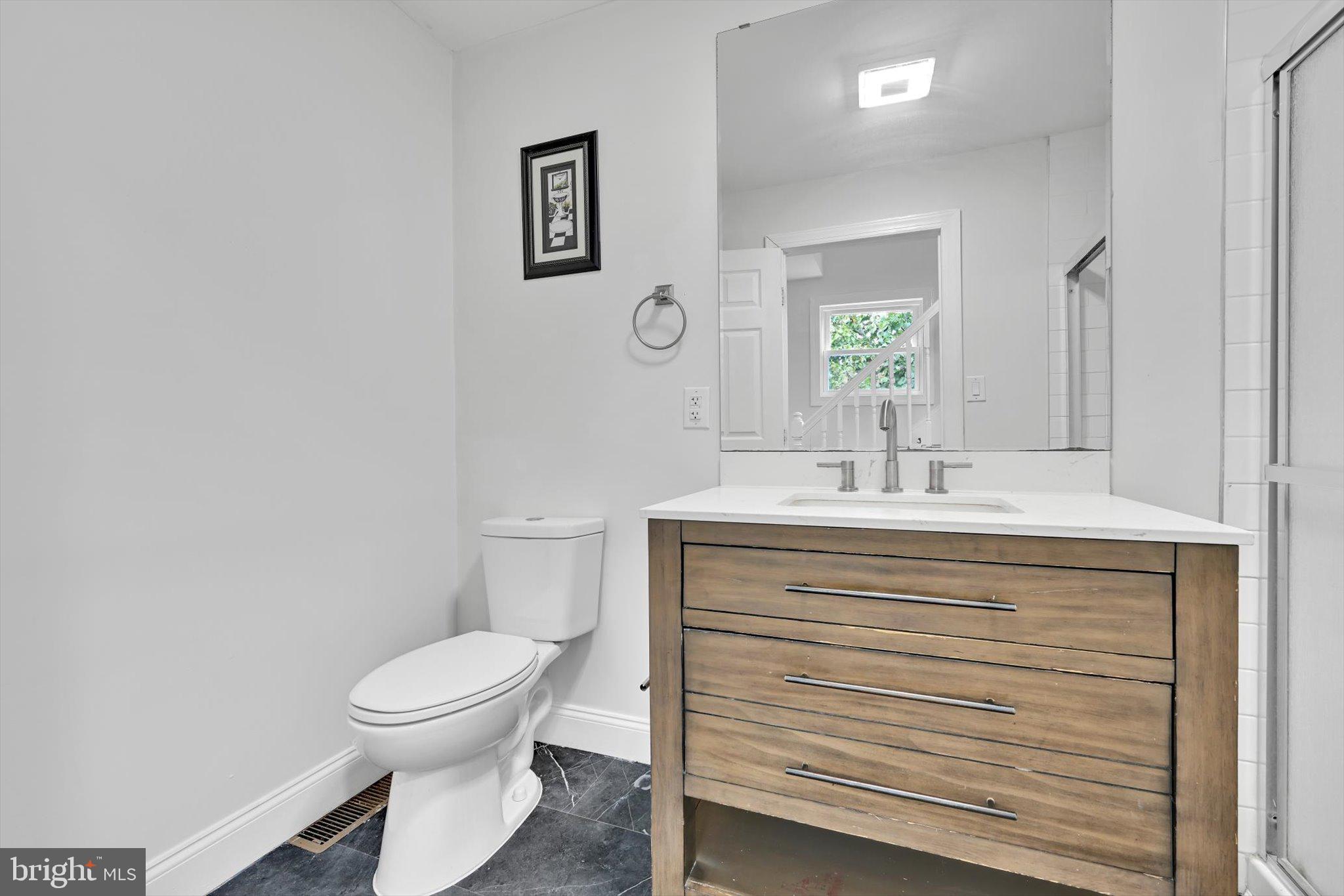 3964 Penn Avenue Sinking Spring, PA 19608 - Photo 20 of 30 a bathroom with a sink mirror vanity and toilet