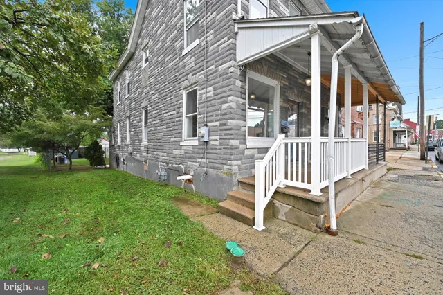 a view of a chair and table in backyard of the house