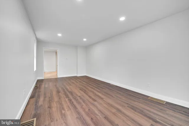 a view of an empty room and wooden floor