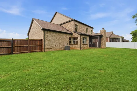 a view of a house with a yard and sitting area