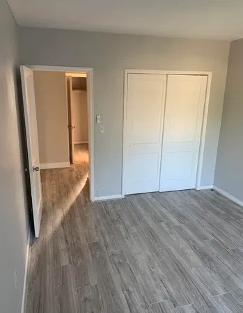 a view of hallway with wooden floor