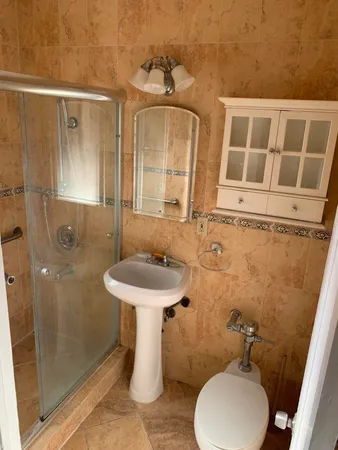 a bathroom with a sink toilet and shower