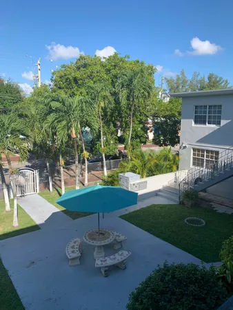 a view of a house with backyard porch and sitting area