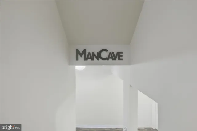 a view of a workspace with furniture and wooden floor