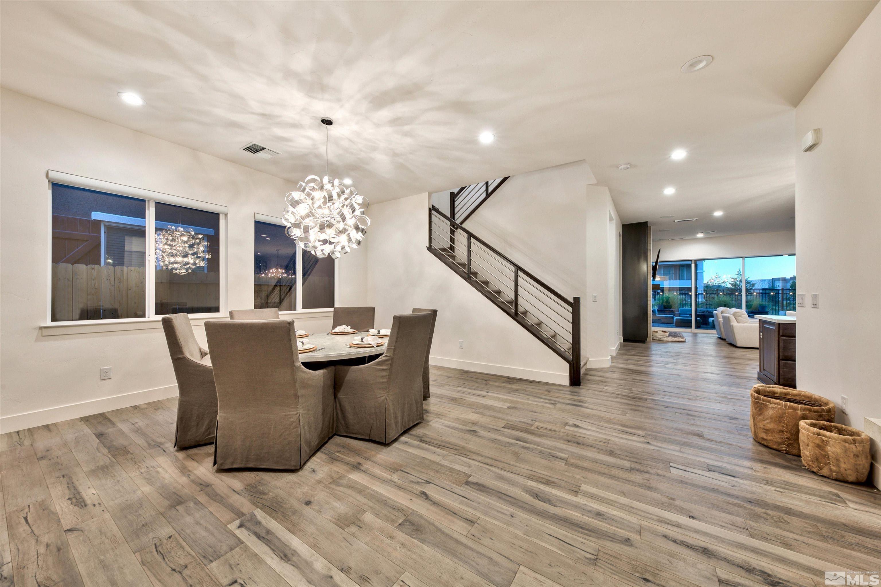 2385 Buttermere Drive Reno, NV 89521 - Photo 11 of 40 a view of a dining room with furniture a chandelier and wooden floor