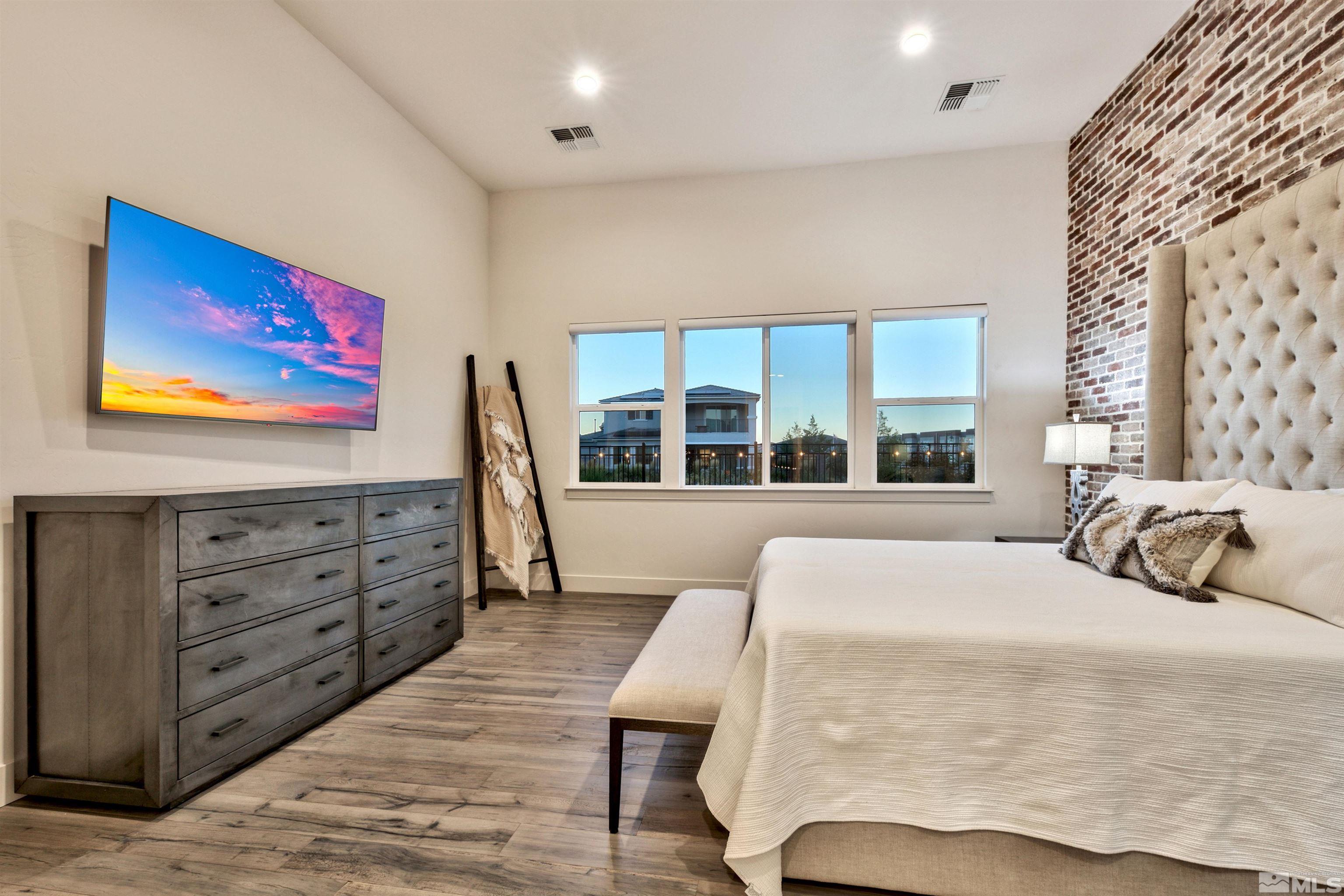 2385 Buttermere Drive Reno, NV 89521 - Photo 13 of 40 a bedroom with a bed and a large window