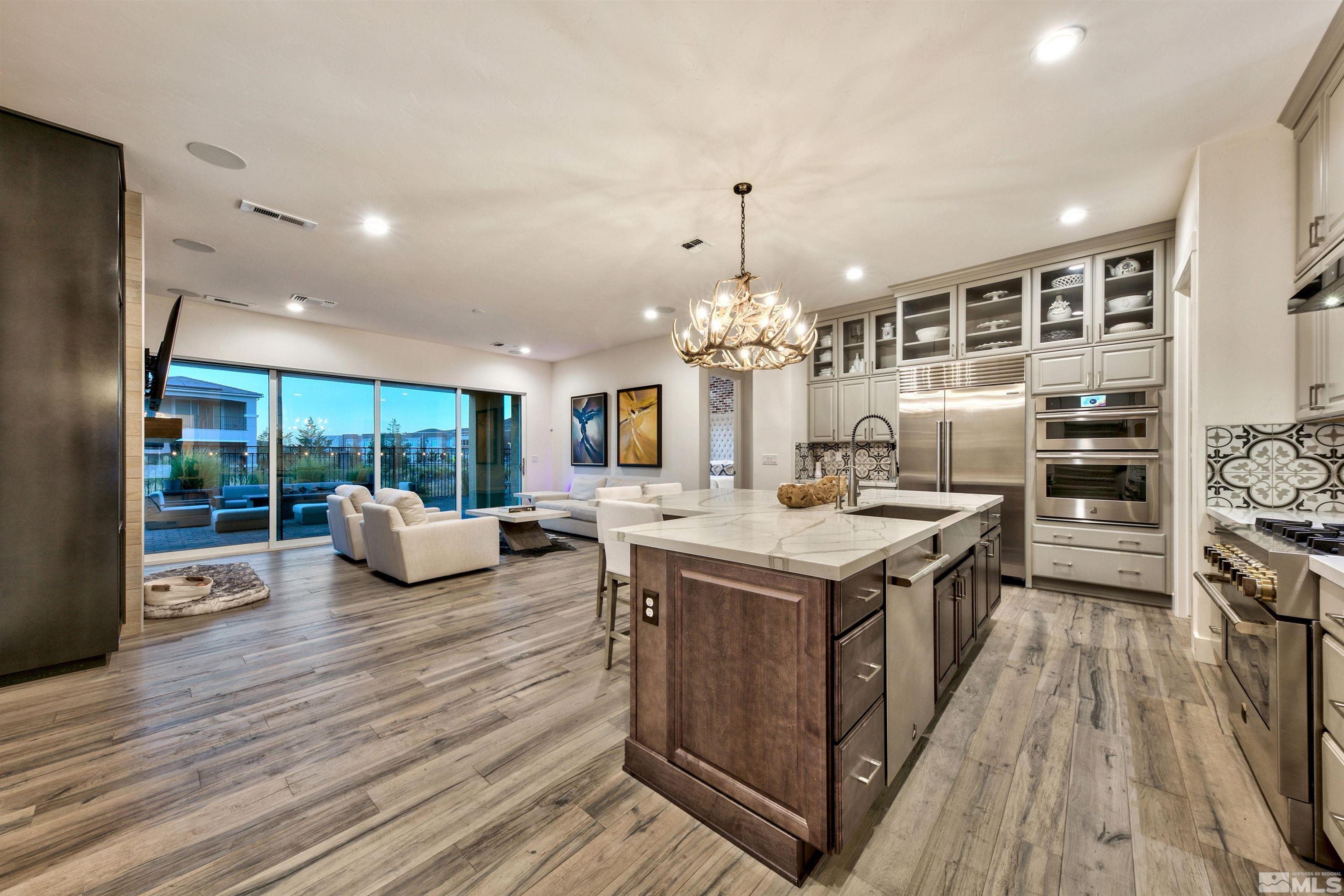 2385 Buttermere Drive Reno, NV 89521 - Photo 3 of 40 a kitchen with stainless steel appliances granite countertop a stove and a wooden floors