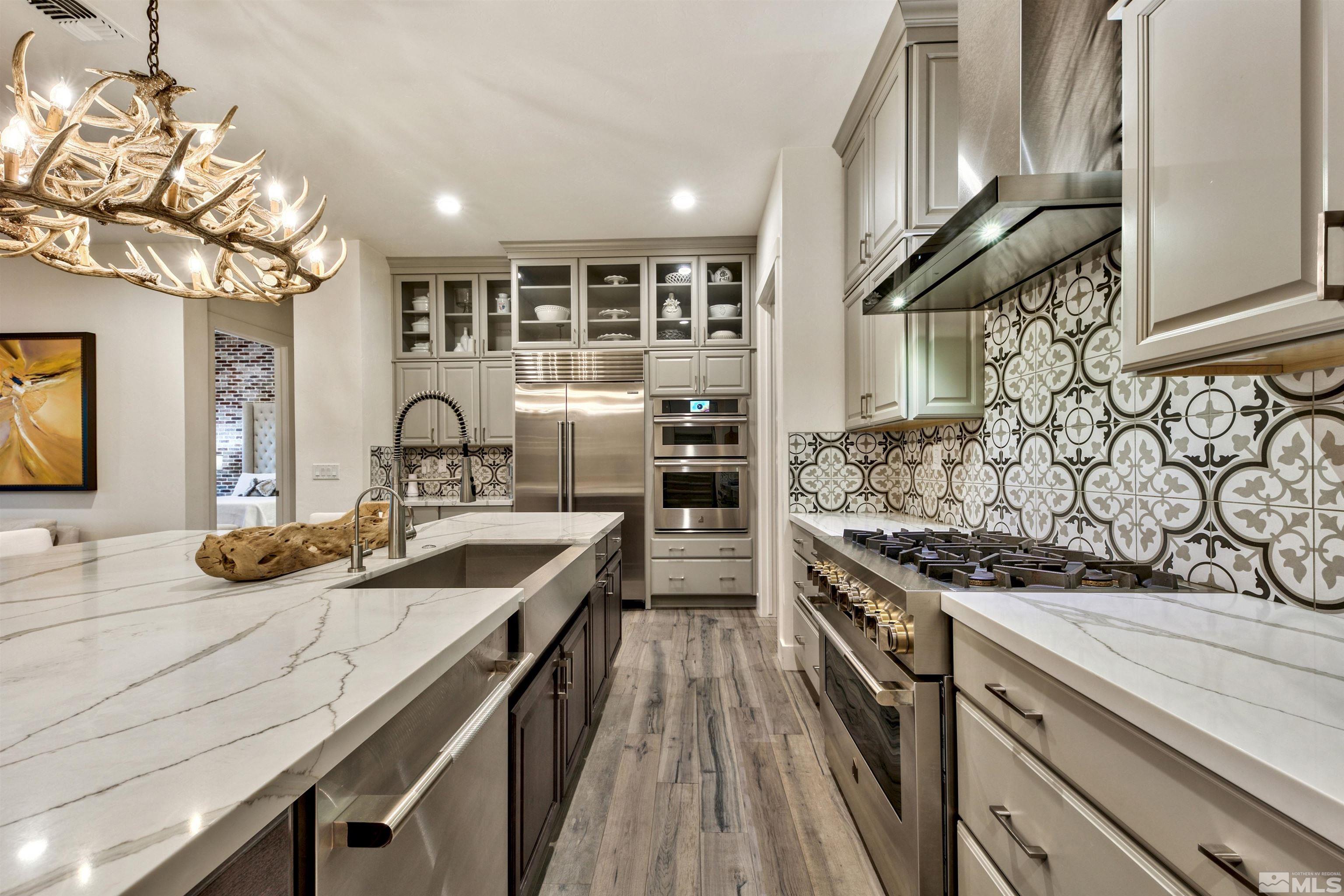 2385 Buttermere Drive Reno, NV 89521 - Photo 6 of 40 a kitchen with stainless steel appliances granite countertop a sink and cabinets