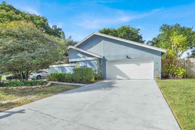a view of a white house with a yard