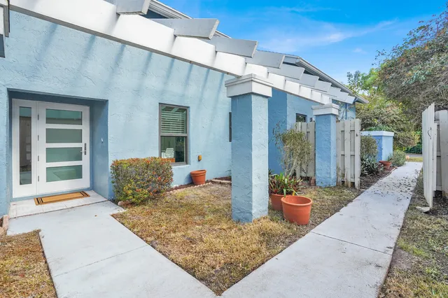 a front view of a house with outdoor seating