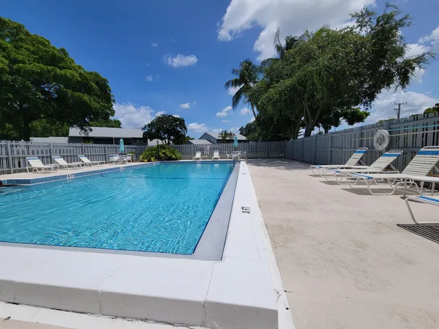a swimming pool with outdoor seating and yard