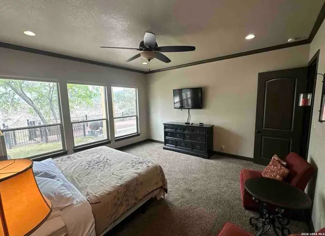 a bathroom with a granite countertop sink mirror vanity and toilet