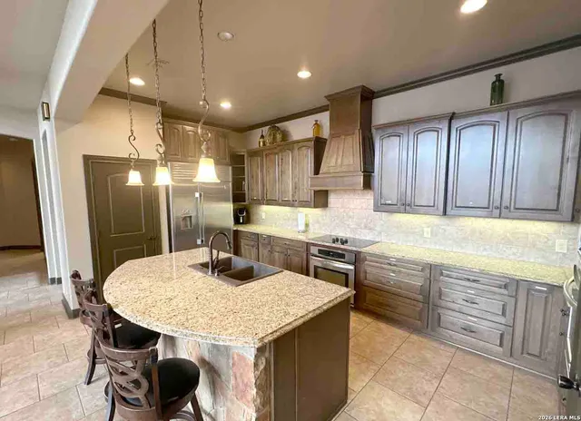 a spacious bedroom with a large bed and a flat tv screen