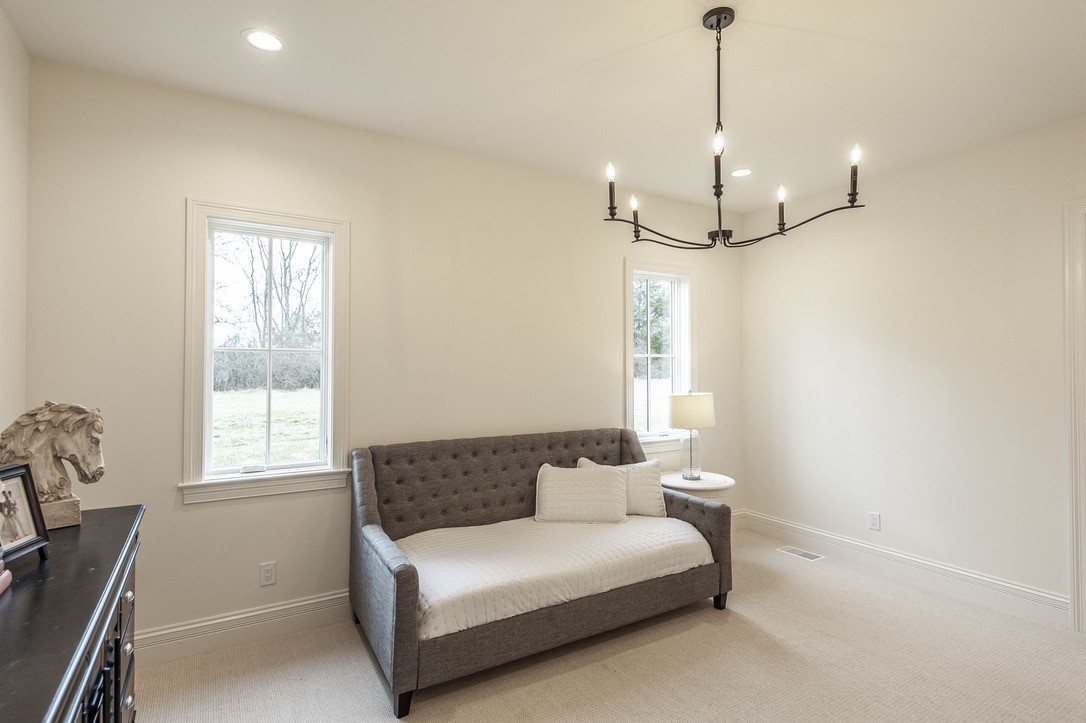 197 E Bugg Hollow Road Cottontown, TN 37048 - Photo 33 of 58 a spacious bedroom with a bed and a window