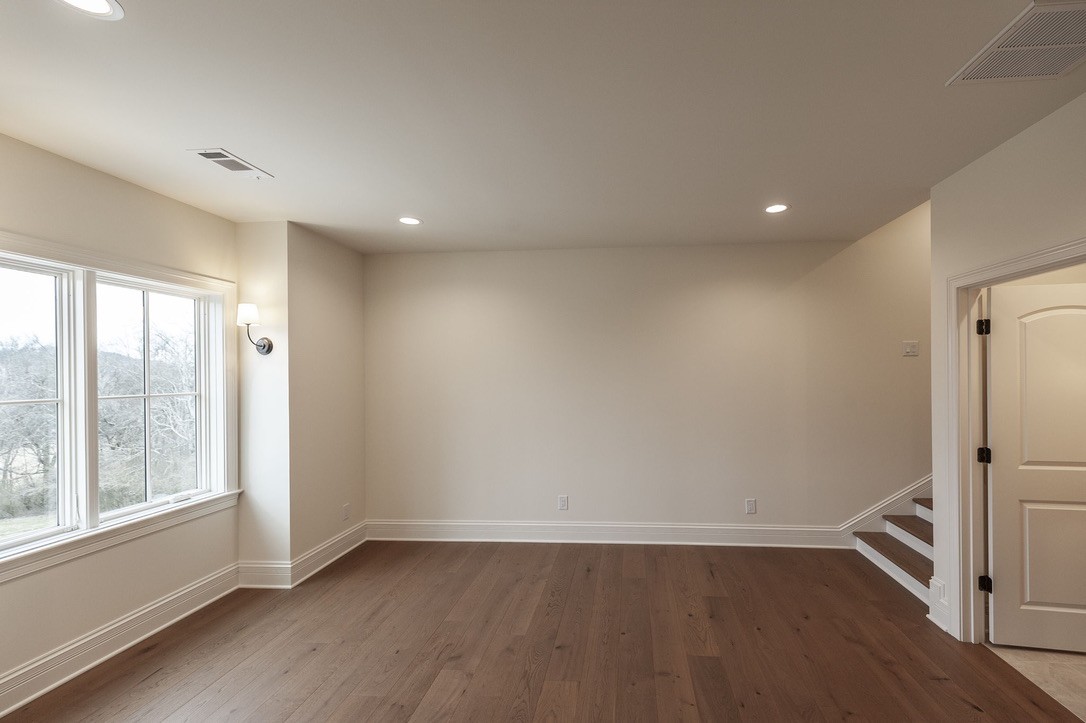 197 E Bugg Hollow Road Cottontown, TN 37048 - Photo 39 of 58 an empty room with wooden floor and windows
