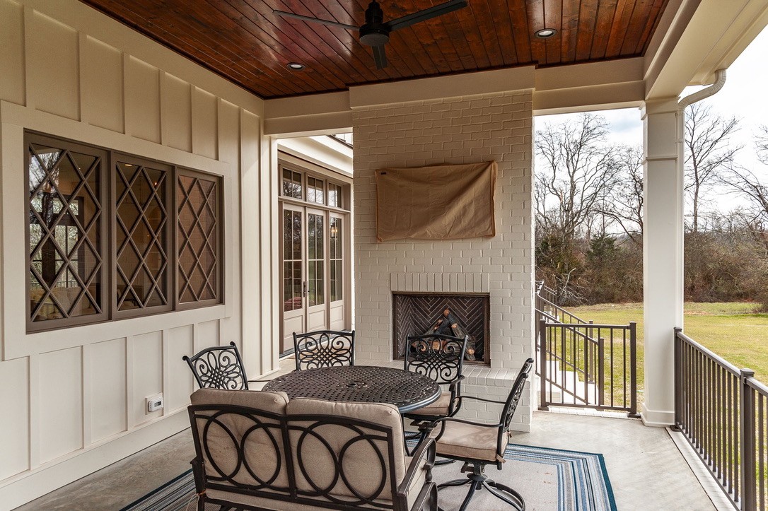 197 E Bugg Hollow Road Cottontown, TN 37048 - Photo 57 of 61 a dining room with furniture a fireplace and wooden floor