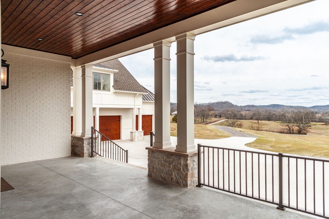 197 E Bugg Hollow Road Cottontown, TN 37048 - Photo 6 of 61 a view of a porch with furniture and floor to ceiling window