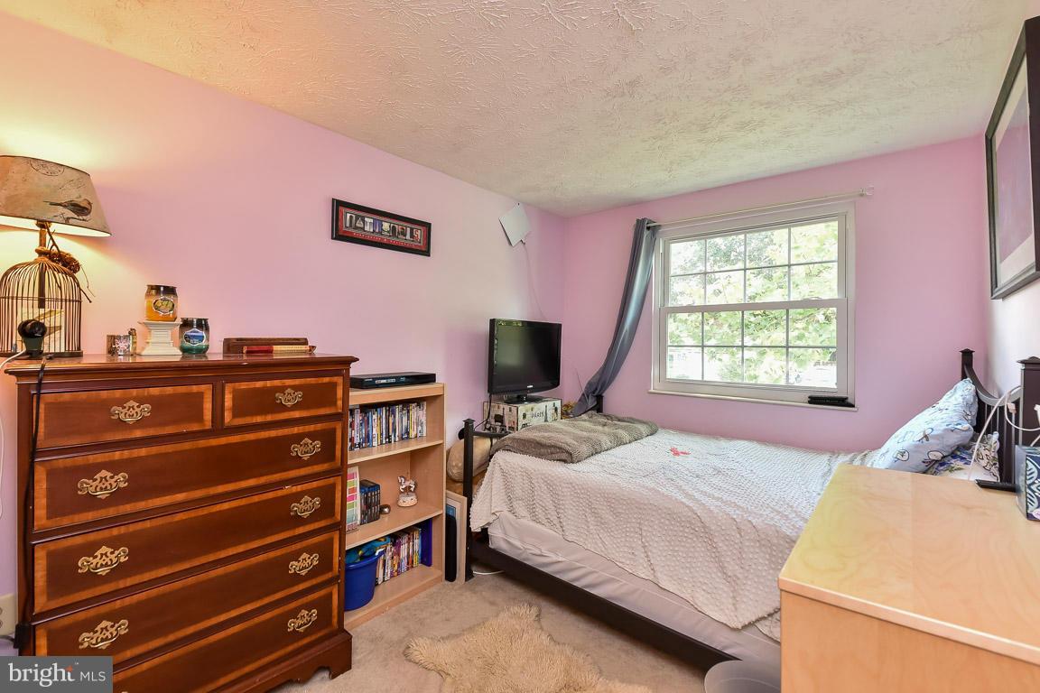5809 Heming Avenue Springfield, VA 22151 - Photo 13 of 22 a bedroom with a bed and a flat screen tv