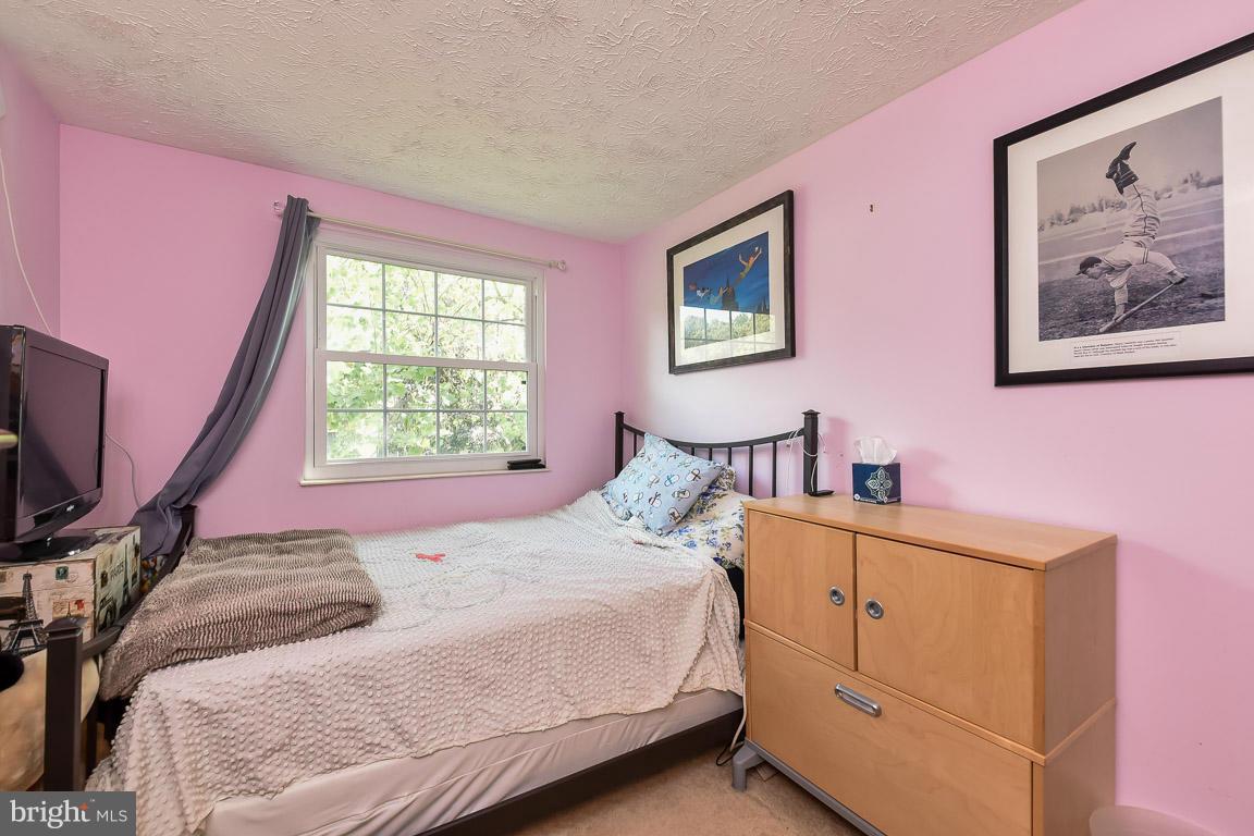5809 Heming Avenue Springfield, VA 22151 - Photo 14 of 22 a bedroom with a bed and a flat screen tv