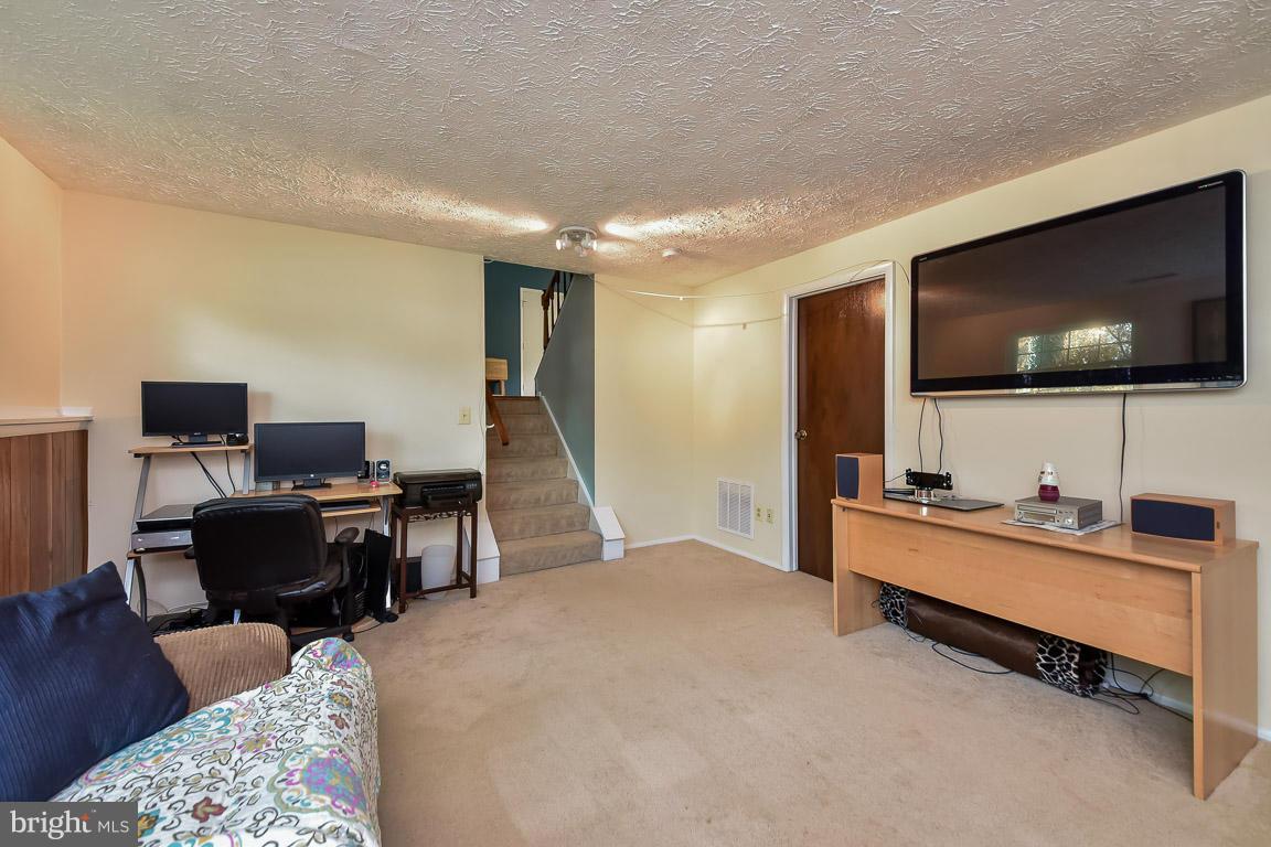 5809 Heming Avenue Springfield, VA 22151 - Photo 15 of 22 a living room with furniture and a flat screen tv