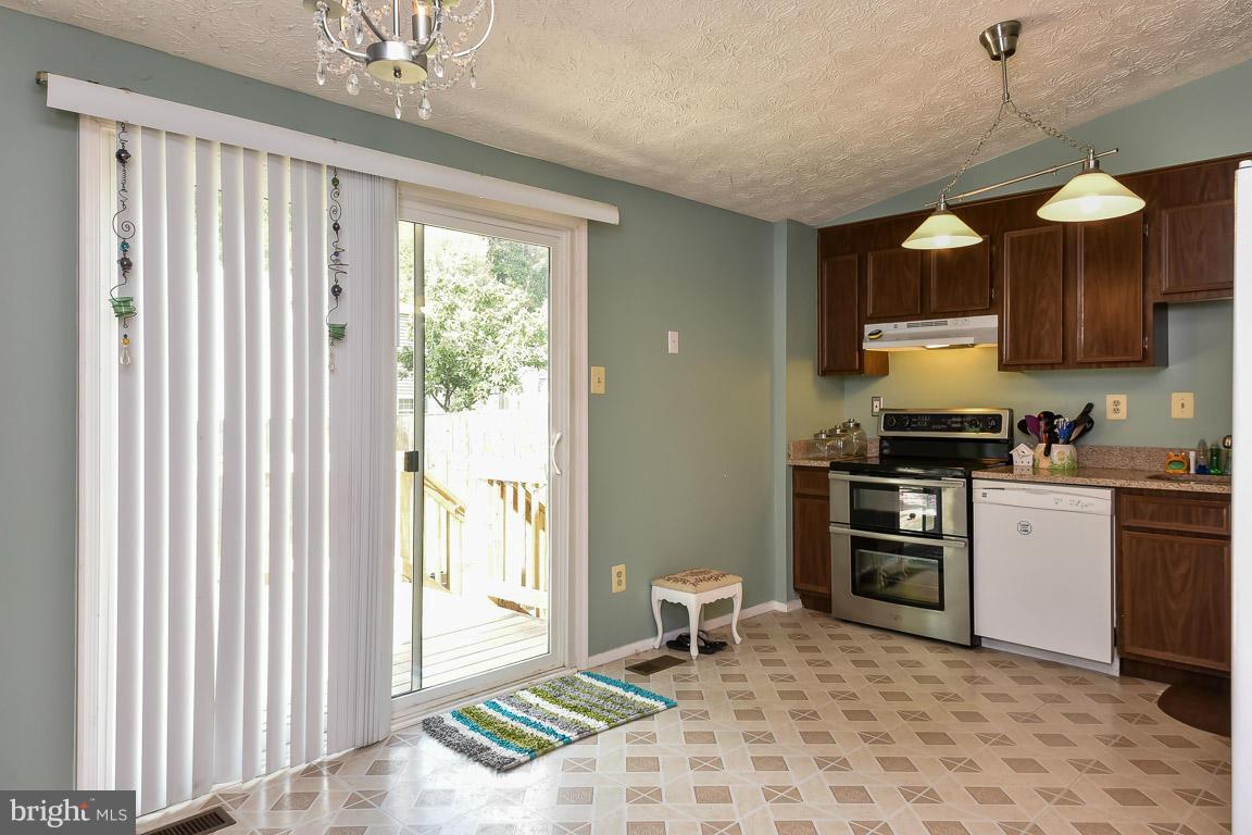 5809 Heming Avenue Springfield, VA 22151 - Photo 5 of 22 a kitchen with stainless steel appliances granite countertop a stove a sink and a refrigerator