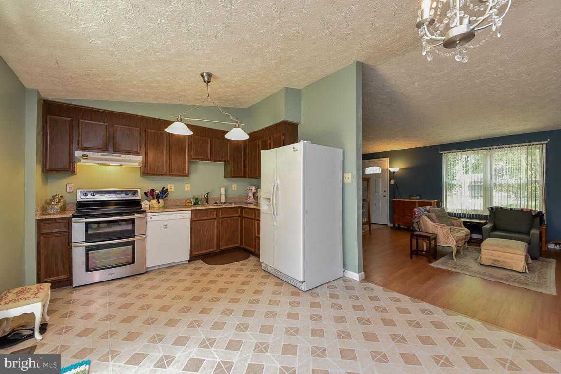 5809 Heming Avenue Springfield, VA 22151 - Photo 6 of 22 a kitchen with a refrigerator and a stove top oven