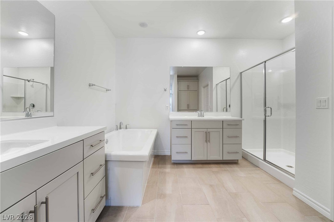 2555 Hampton Road, Unit 10202 Henderson, NV 89052 - Photo 31 of 35 A glass-enclosed shower, built-in soaking tub, and dual vanities define this modern bathroom.