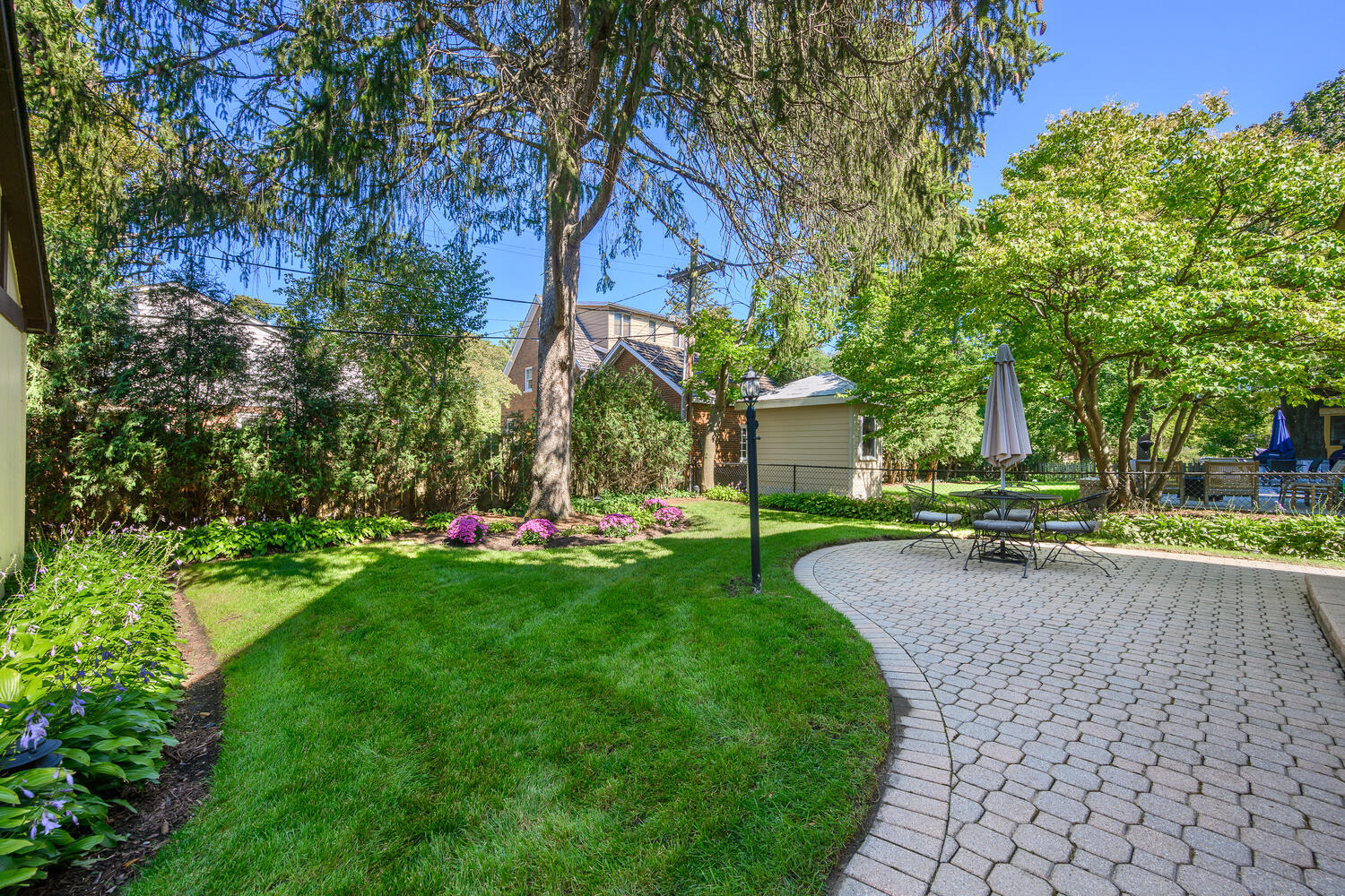 26 Park Lane Golf, IL 60029 - Photo 4 of 6 a view of a yard with plants and a bench